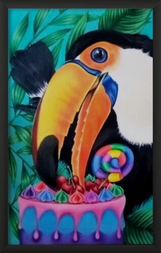 Toco toucan, leaning forward with a cherry in its beak from the top of the birthday cake. Rainbow cake with lollipop on the top, colourful icing dripping down the sides. Background of leaves and turquoise background. Framed painting.