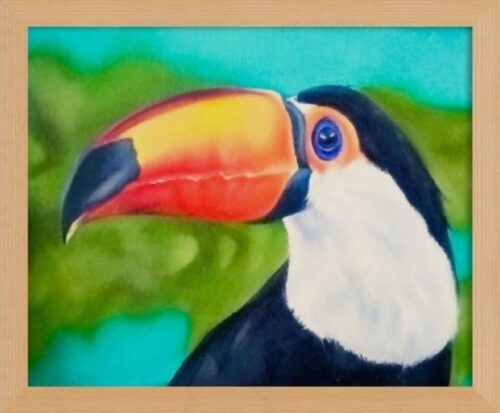 Portrait of a toco toucan with bright beak in yellow, orange and blue tones. Treetop background with a turquoise sky. Framed painting.