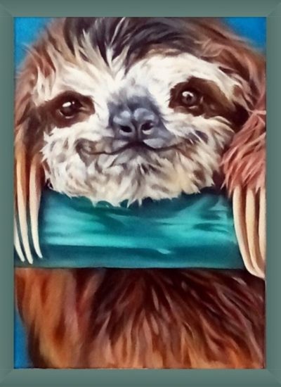 Image of a young sloth, very cute face, smiling with bright brown eyes. The head is resting on a green bar with paws holding onto the bar. Cream hair on the face and brown and orange hair on the head and body. Framed painting.